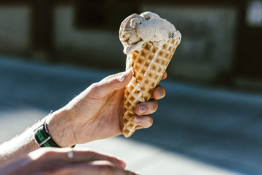 melting ice cream cone being held by a person. photo by priscilla du preez, unsplash