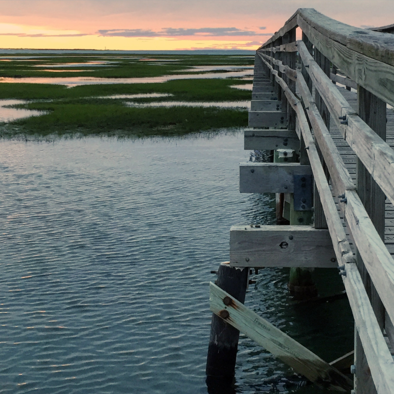 sunset over the marsh at the bass hole boardwalk in Yarmouth, massachusetts